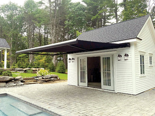 an extended Series G250 Retractable Awning on a pool house