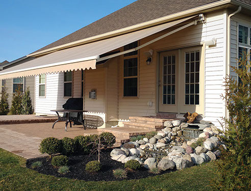 a Series 8700 Retractable Awning covering a patio
